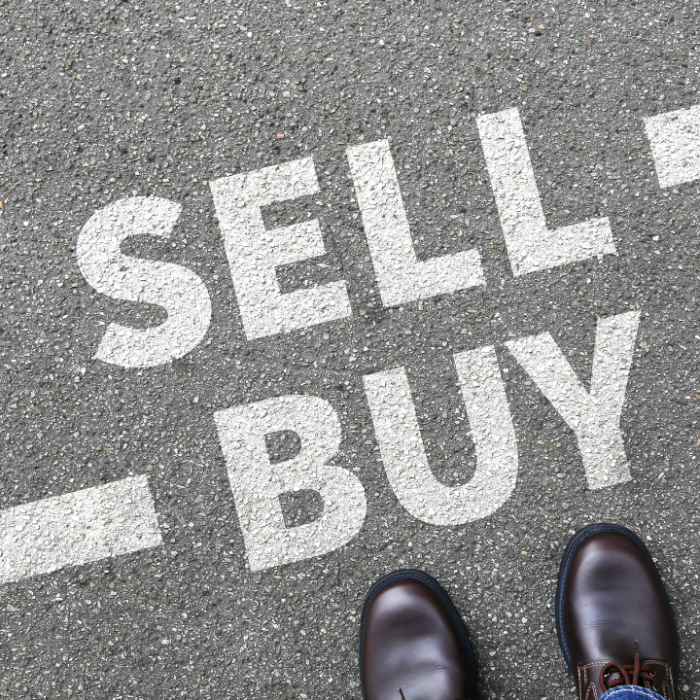 Image of a road with an arrow pointing to the right labelled sell and an arrow pointing to the left labelled buy