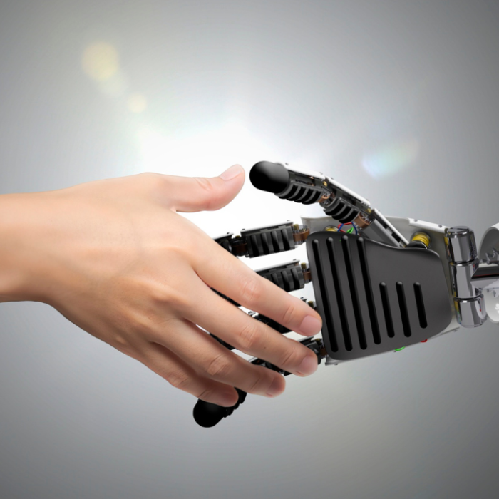 Image of a human hand shaking hands with a robotic hand.