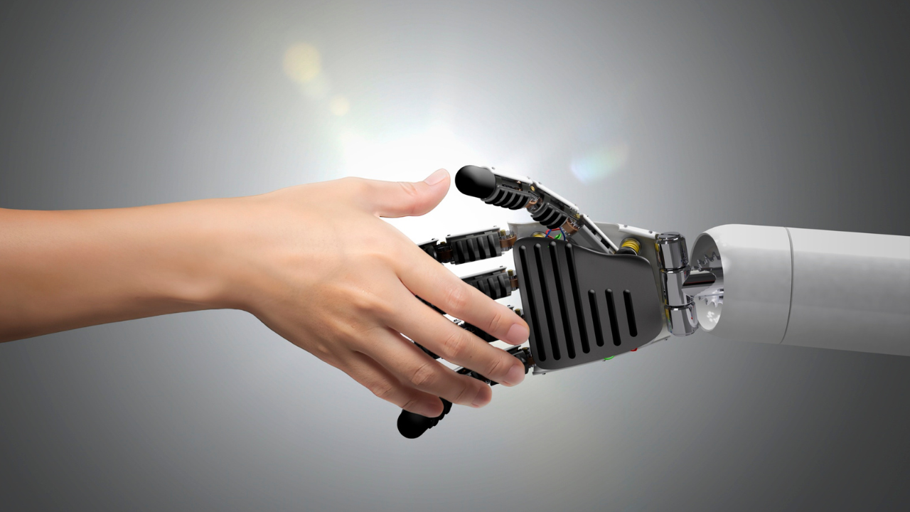 Image of a human hand shaking hands with a robotic hand.